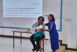 The trainees being shown the correct breastfeeding techniques by Prof Grace Irimu.